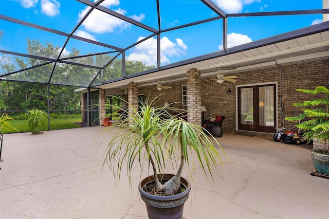 view of patio / terrace featuring ceiling fan, glass enclosure, and french doors