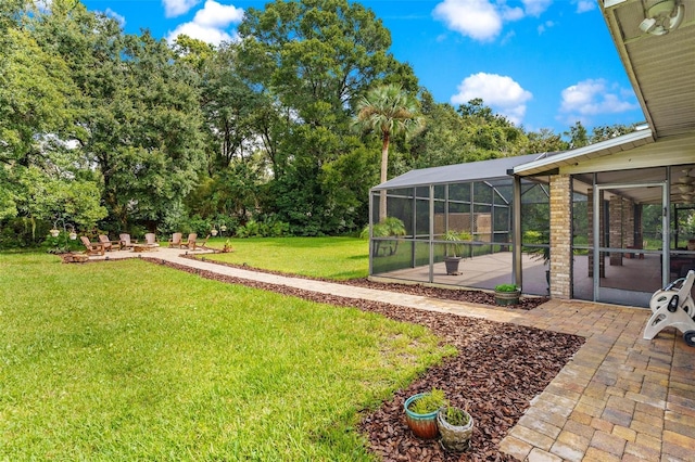 view of yard featuring glass enclosure and a patio area