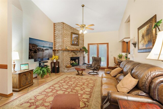 living room with ceiling fan, light tile patterned floors, high vaulted ceiling, and a brick fireplace