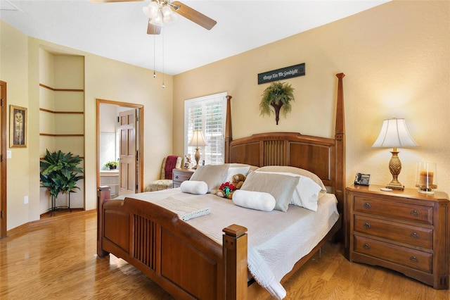 bedroom with light wood-type flooring, connected bathroom, and ceiling fan