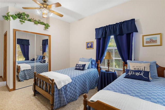 carpeted bedroom featuring ceiling fan and a closet