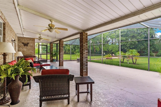 view of patio with outdoor lounge area, ceiling fan, and glass enclosure