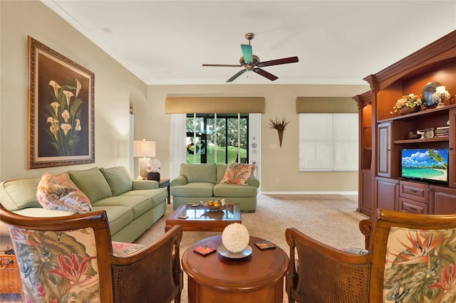 carpeted living room featuring ceiling fan and ornamental molding