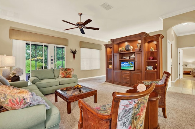 carpeted living room with ceiling fan and crown molding