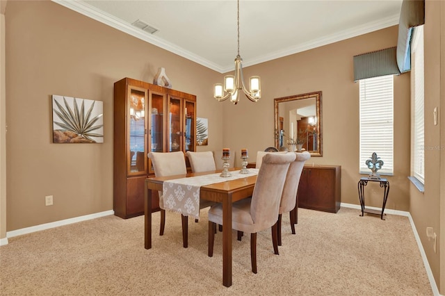 carpeted dining space featuring a chandelier and ornamental molding