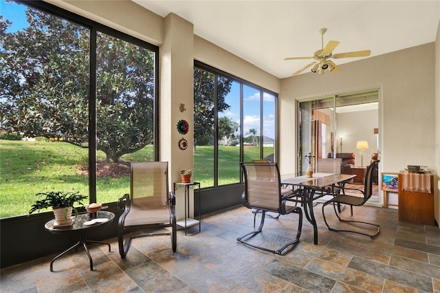 sunroom featuring ceiling fan