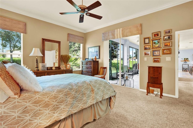 carpeted bedroom with ceiling fan and ornamental molding