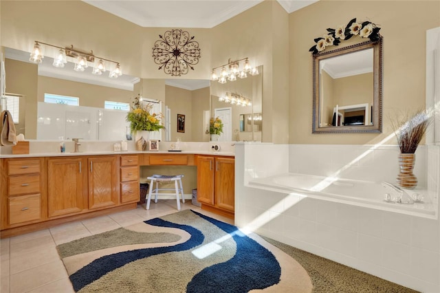 bathroom with tile patterned floors, tiled bath, crown molding, and vanity