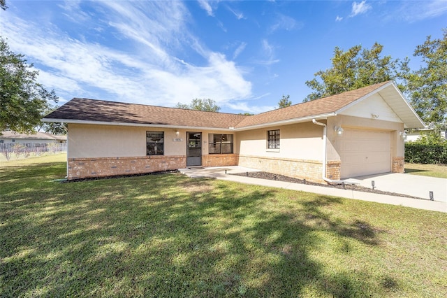 single story home with a front yard and a garage