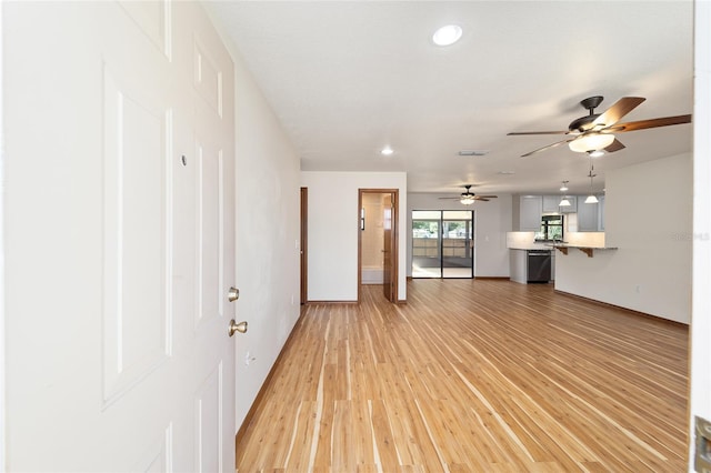 unfurnished living room with light hardwood / wood-style flooring and ceiling fan