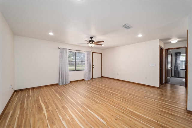 unfurnished room with light wood-type flooring and ceiling fan