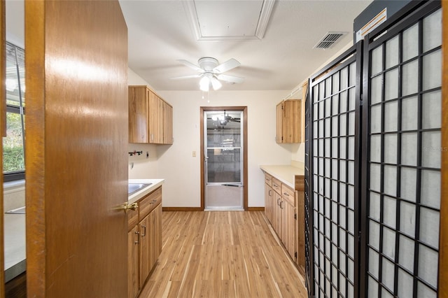 kitchen with ceiling fan and light hardwood / wood-style flooring