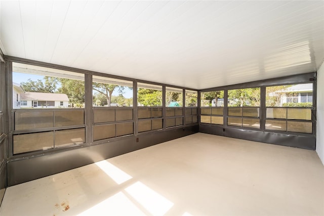 unfurnished sunroom with plenty of natural light and vaulted ceiling