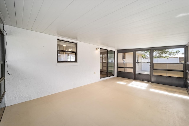 unfurnished sunroom featuring wooden ceiling