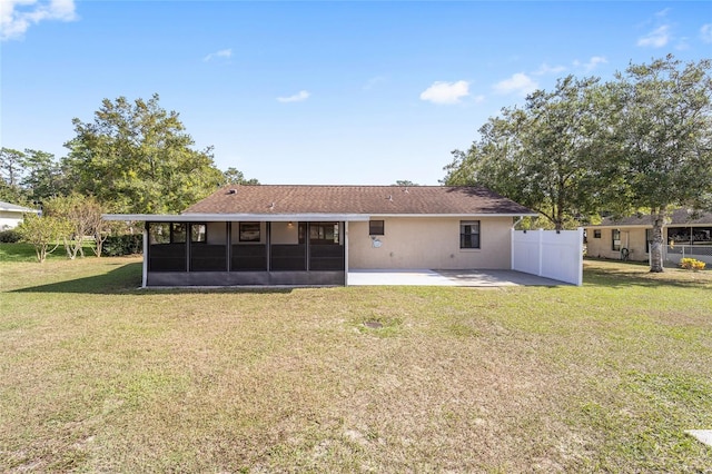 back of house featuring a sunroom, a yard, and a patio