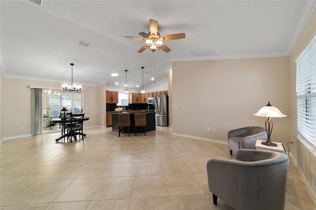 living room featuring light tile patterned floors, vaulted ceiling, plenty of natural light, and crown molding