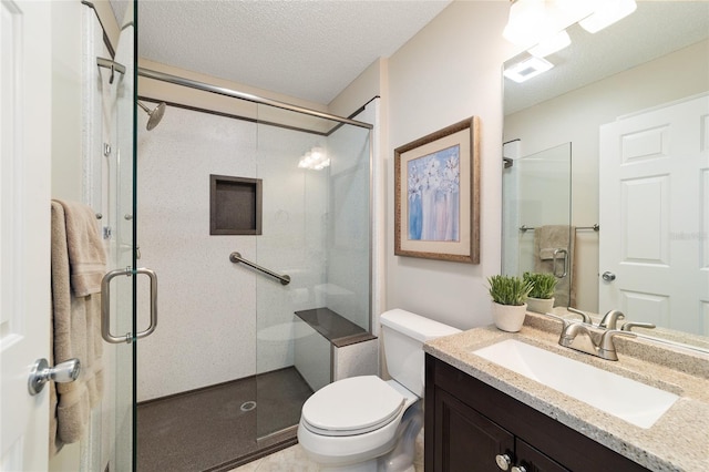 bathroom featuring a stall shower, visible vents, toilet, a textured ceiling, and vanity