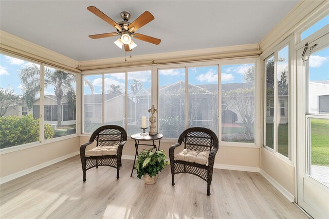 sunroom / solarium featuring plenty of natural light and ceiling fan