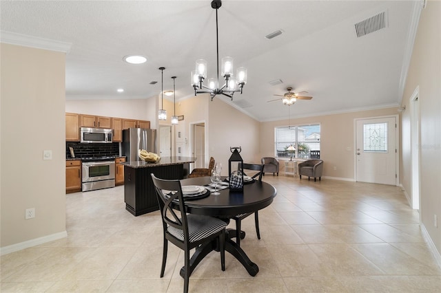 dining room with lofted ceiling, visible vents, and crown molding