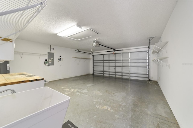 garage with electric panel and a sink