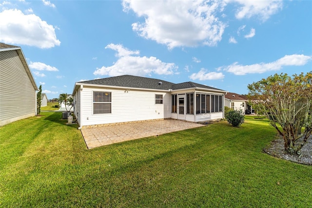 rear view of property featuring a patio area, a sunroom, and a yard