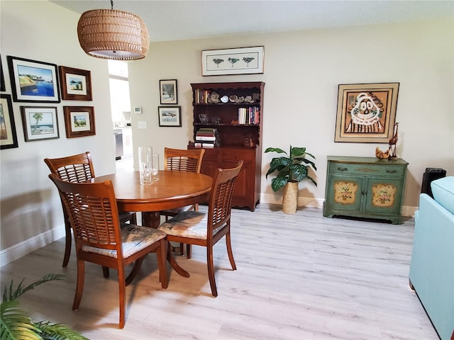 dining space with light hardwood / wood-style floors