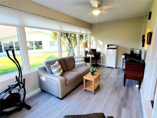 sunroom featuring ceiling fan