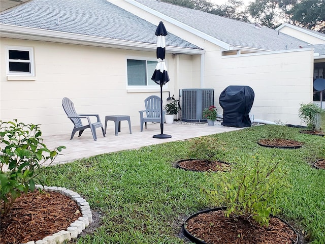 view of yard featuring a patio area and central air condition unit