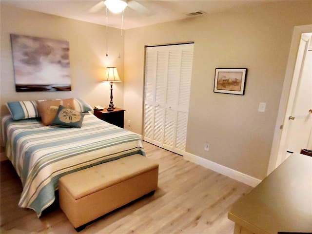 bedroom with ceiling fan, a closet, and light hardwood / wood-style floors