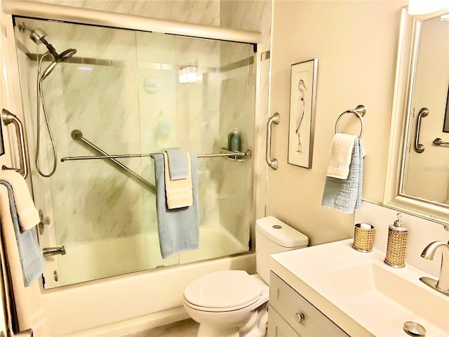 full bathroom featuring shower / bath combination with glass door, vanity, and toilet