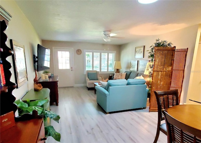 living room with ceiling fan and light hardwood / wood-style flooring