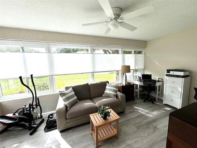 sunroom featuring ceiling fan and a healthy amount of sunlight