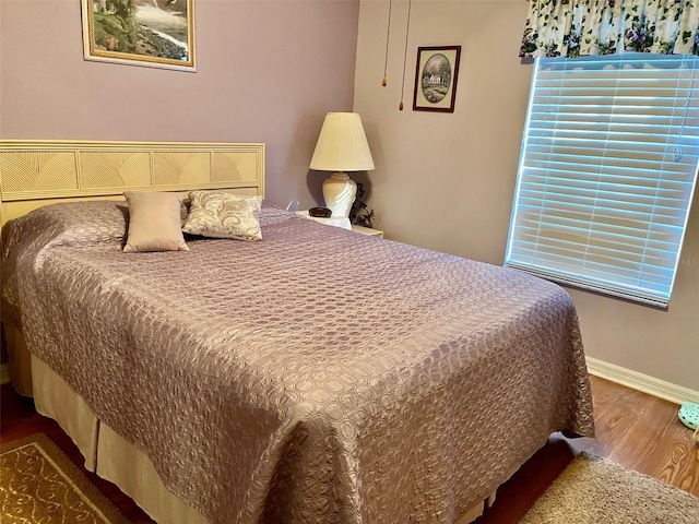 bedroom with wood-type flooring