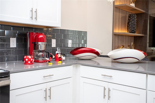 kitchen featuring backsplash and white cabinetry