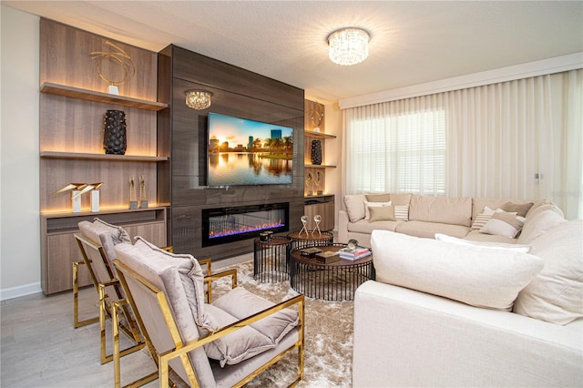 living room featuring a fireplace, a textured ceiling, and light hardwood / wood-style flooring