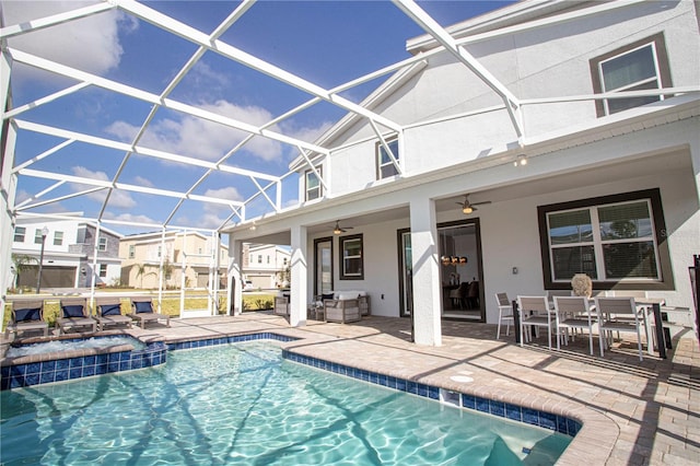 view of pool featuring an in ground hot tub, glass enclosure, ceiling fan, and a patio area