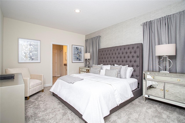 carpeted bedroom featuring ensuite bath