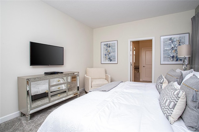 bedroom with carpet floors and a textured ceiling