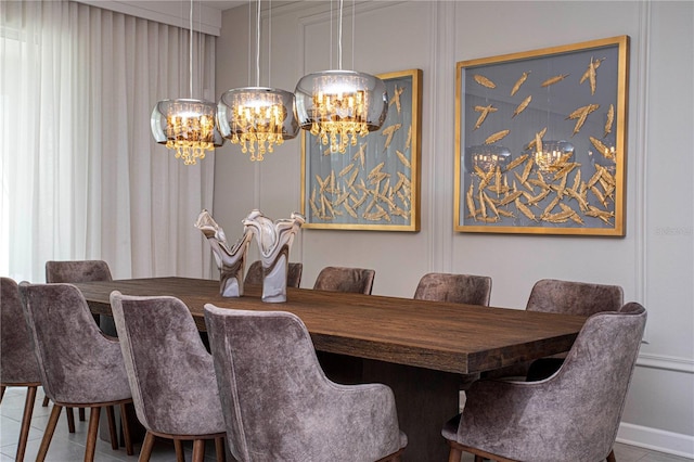 tiled dining room with a chandelier