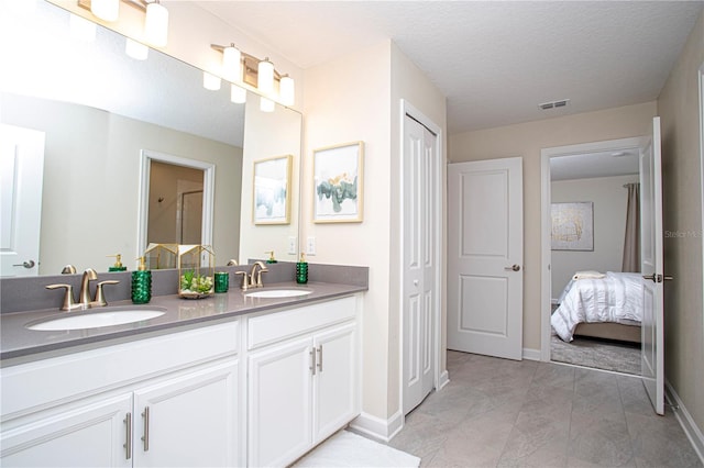 bathroom with vanity and a textured ceiling