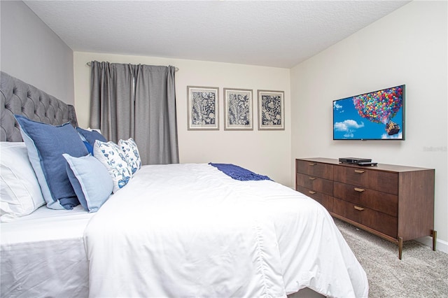 carpeted bedroom with a textured ceiling