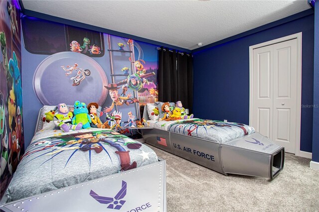 carpeted bedroom featuring a closet and a textured ceiling