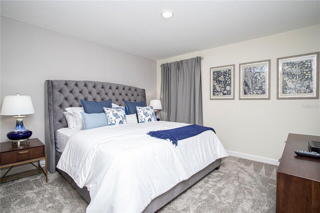 carpeted bedroom with a textured ceiling