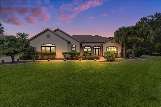 view of front of property with a lawn