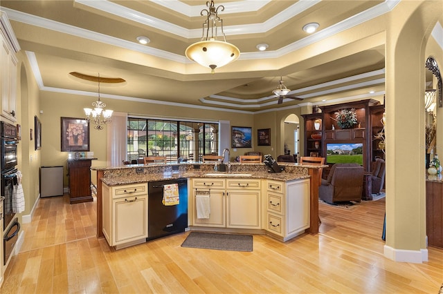 kitchen featuring black dishwasher, decorative light fixtures, a raised ceiling, and ornamental molding