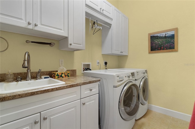 clothes washing area featuring light tile patterned flooring, cabinets, sink, and washing machine and dryer