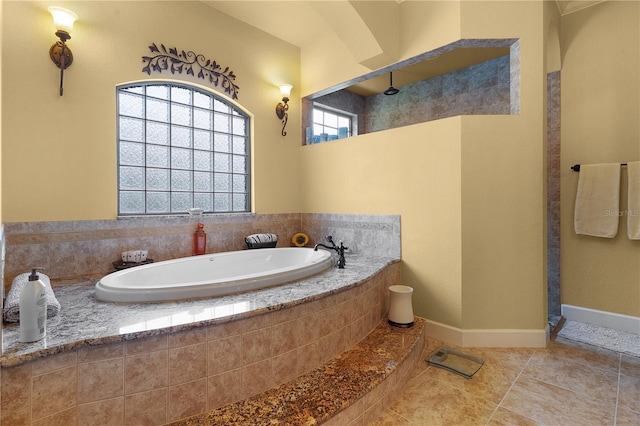 bathroom with tile patterned flooring and shower with separate bathtub