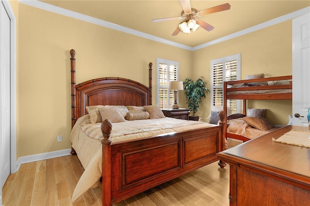 bedroom featuring ceiling fan, light hardwood / wood-style floors, and ornamental molding