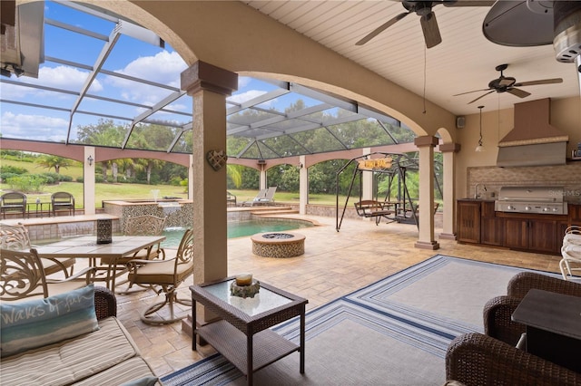 view of patio / terrace featuring ceiling fan, a lanai, a grill, pool water feature, and area for grilling