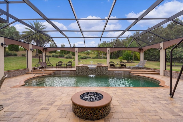 view of swimming pool with pool water feature, a lanai, a yard, a patio area, and an outdoor fire pit